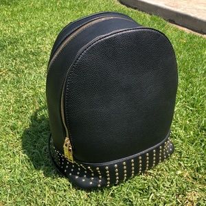 Black backpack with gold zipper